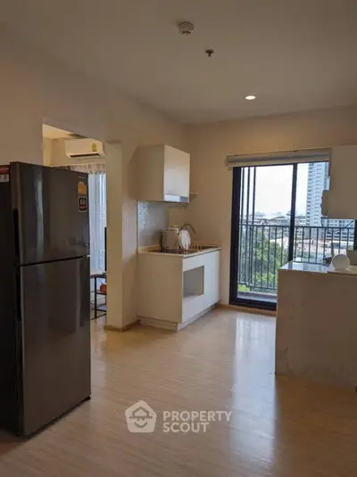 Modern kitchen with open layout and balcony view in a stylish apartment.