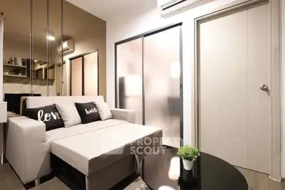 Modern living room with stylish decor and cozy seating in a contemporary apartment.