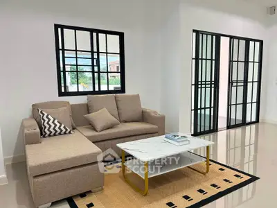 Modern living room with stylish sofa and coffee table in bright interior