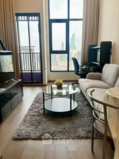 Modern living room with city view, featuring cozy sofa, glass coffee table, and floor-to-ceiling windows.