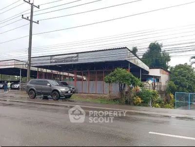 Commercial property with spacious parking area and roadside access, ideal for business opportunities.