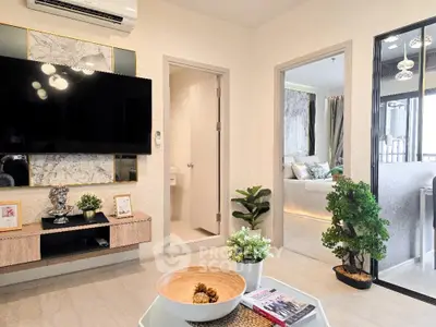 Modern living room with stylish decor and open view into bedroom