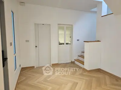 Spacious modern interior with elegant wooden flooring and staircase