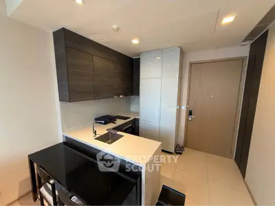 Modern kitchen with sleek cabinetry and integrated appliances in a stylish apartment.