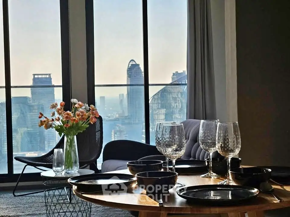 Luxurious living room with stunning city view, elegant decor, and modern furnishings in high-rise apartment.