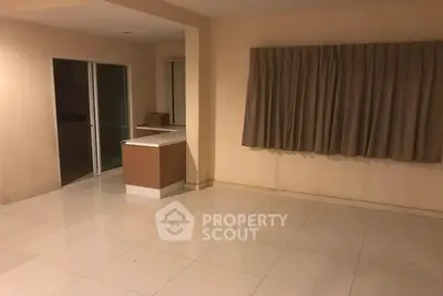 Spacious empty room with tiled flooring and sliding glass doors