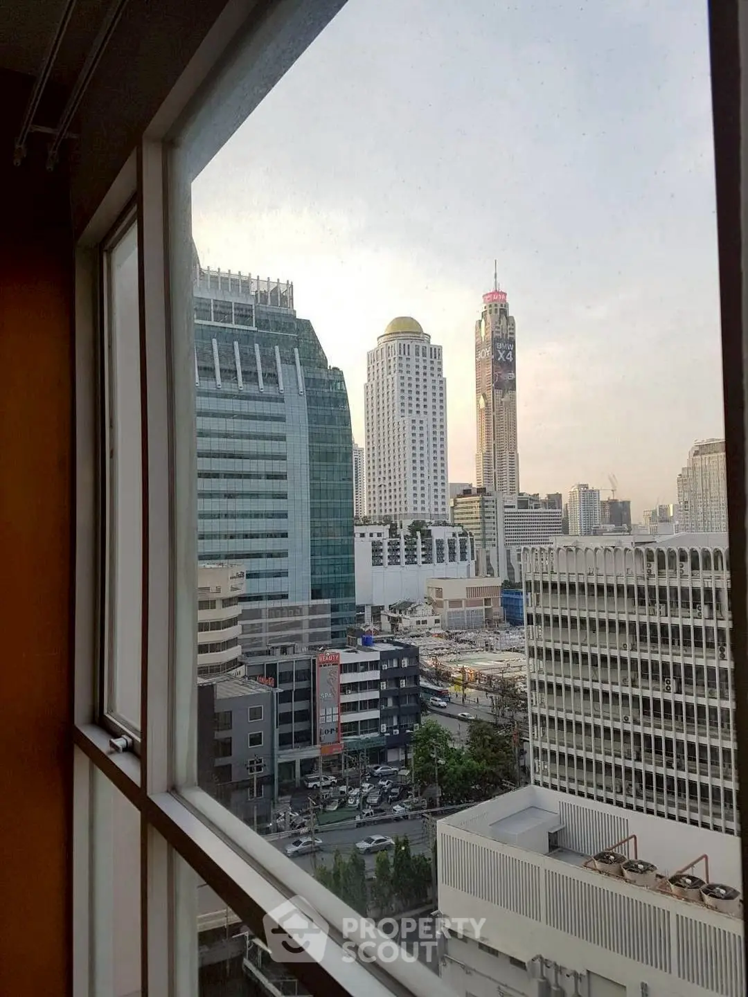 Stunning cityscape view from high-rise window, showcasing modern architecture and urban skyline.