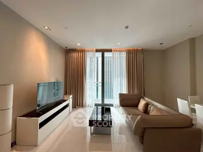 Modern living room with sleek furniture and large window for natural light.