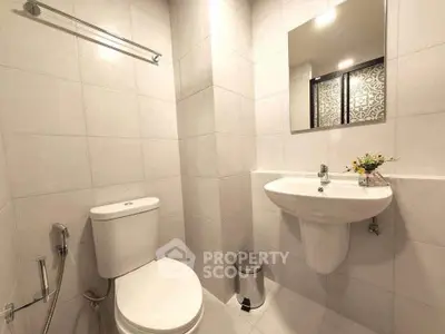 Modern bathroom with sleek fixtures and elegant tile design, perfect for a contemporary home.