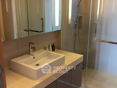 Modern bathroom with sleek fixtures and glass shower enclosure