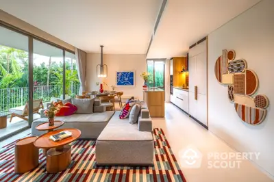 Spacious modern living room with open kitchen and large balcony overlooking lush greenery.