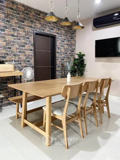Modern dining area with brick accent wall and stylish wooden furniture