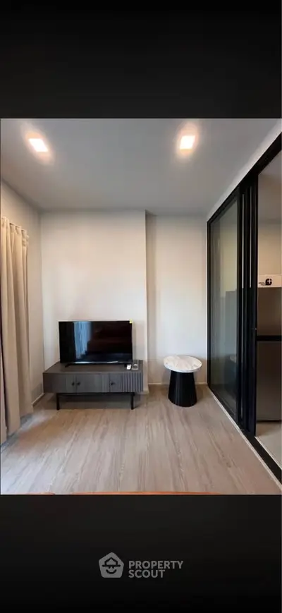 Modern living room with sleek TV stand and glass sliding doors
