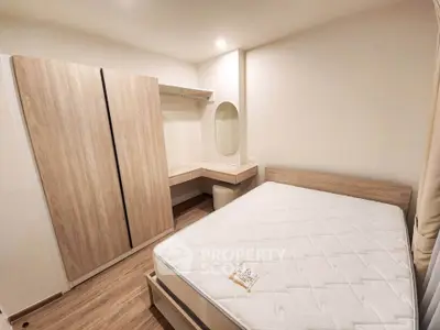 Cozy bedroom with modern wooden furniture and comfortable mattress in a minimalist design.