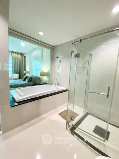 Luxurious bathroom with glass shower and bathtub in modern apartment