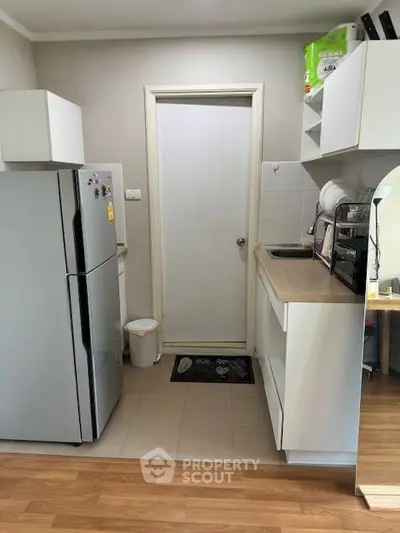 Compact kitchen with modern appliances and closed layout