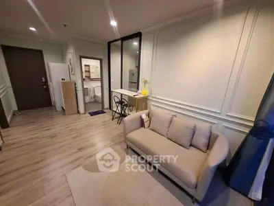Modern living room with cozy sofa and open kitchen layout