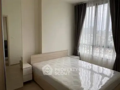 Bright and cozy bedroom with large window and modern furnishings