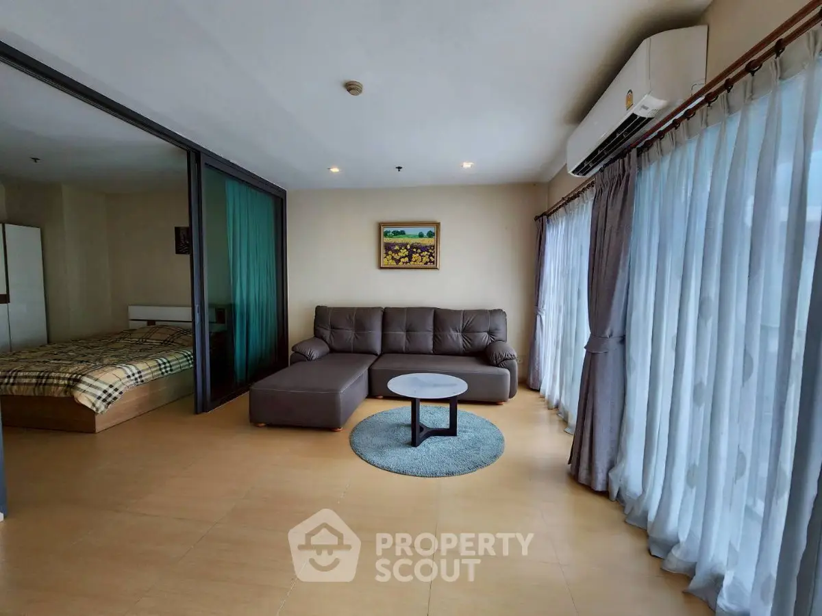 Spacious living room with modern sofa and large windows in a stylish apartment