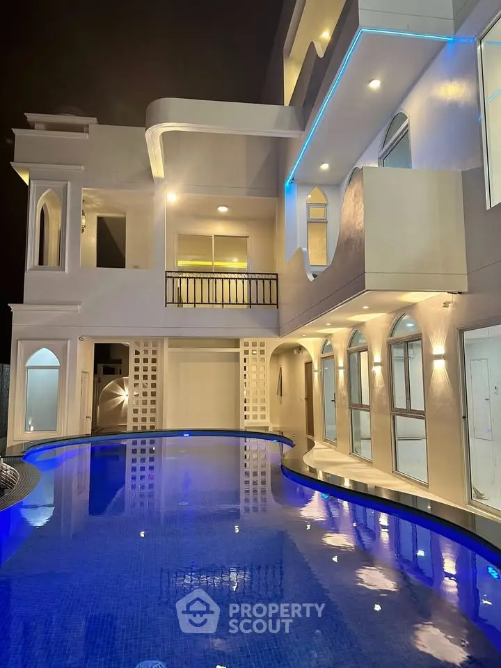 Luxurious modern villa with stunning illuminated pool and elegant architecture