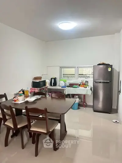 Spacious kitchen with dining area and modern appliances in a cozy home setting.
