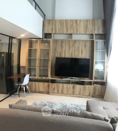 Modern living room with stylish wooden entertainment center and cozy seating area