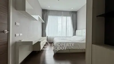 Modern minimalist bedroom with large window and sleek furnishings