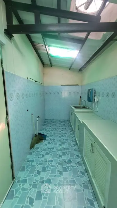 Spacious kitchen with blue tile flooring and ample counter space