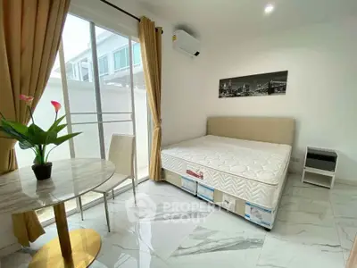 Bright bedroom with large window, modern decor, and marble flooring in a stylish apartment.