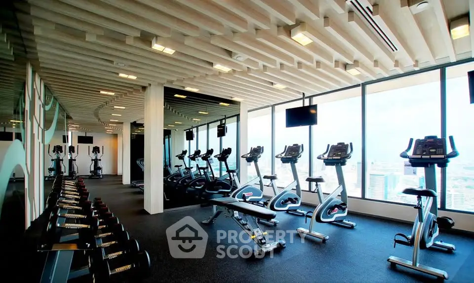 Modern gym with panoramic city views and state-of-the-art fitness equipment.