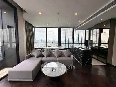 Luxurious modern living room with panoramic city views and sleek kitchen design.