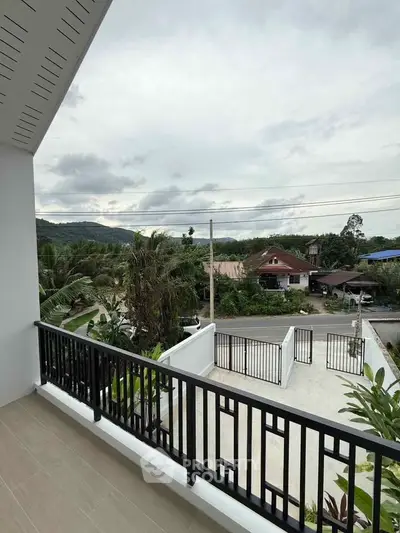 Spacious balcony with scenic mountain views in a serene neighborhood.