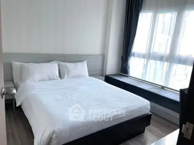 Modern bedroom with large window and minimalist design