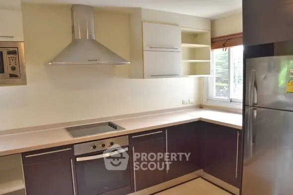 Modern kitchen with sleek cabinetry and stainless steel appliances in a bright, airy space.