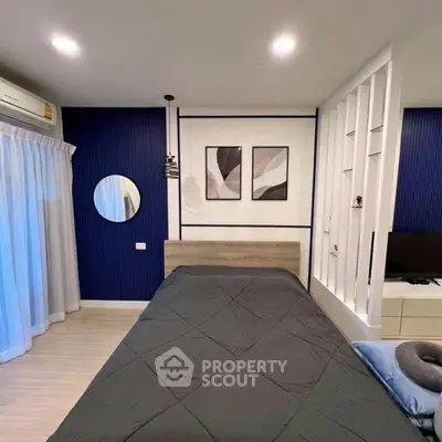 Modern bedroom with stylish decor and ambient lighting, featuring a cozy bed and elegant wall art.