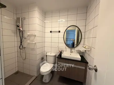Modern bathroom with sleek fixtures and stylish vanity in a contemporary apartment.