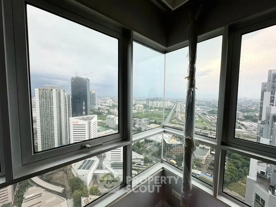 Stunning cityscape view from high-rise apartment corner window