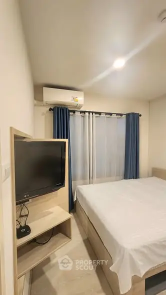 Cozy bedroom with modern amenities and natural light