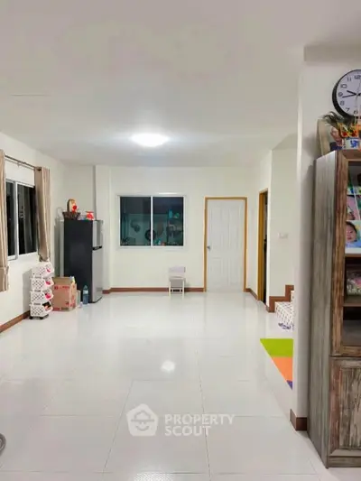 Spacious living area with modern decor and ample natural light