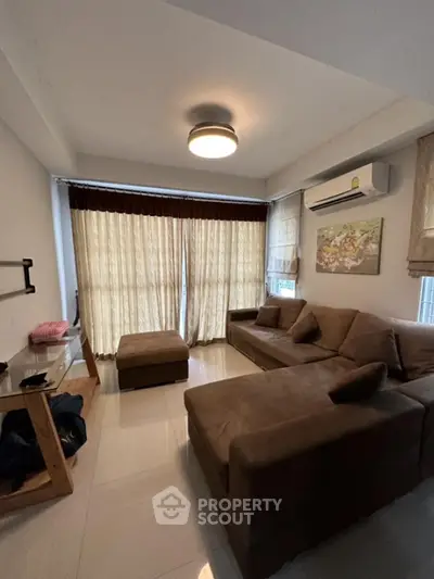 Cozy living room with brown sofa and modern decor in a bright apartment