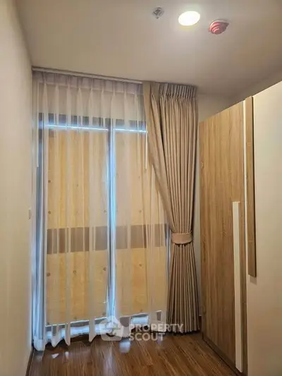 Cozy bedroom corner with elegant curtains and wooden wardrobe