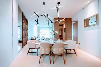 Luxurious modern dining area with elegant lighting and stylish decor in a high-end apartment.