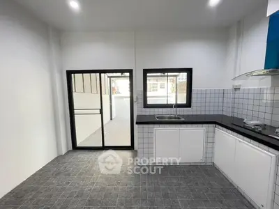 Modern kitchen with sleek black countertops and tiled backsplash
