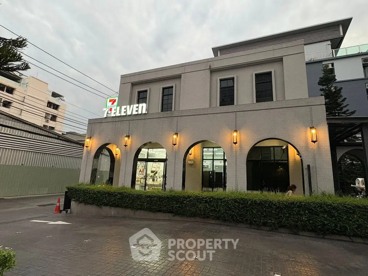 Modern commercial building with iconic 7-Eleven signage and elegant exterior lighting.