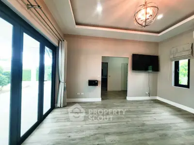 Spacious modern living room with large windows and stylish lighting