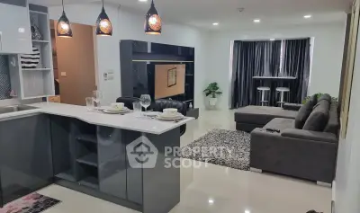 Modern open-layout living room with sleek kitchen and stylish decor