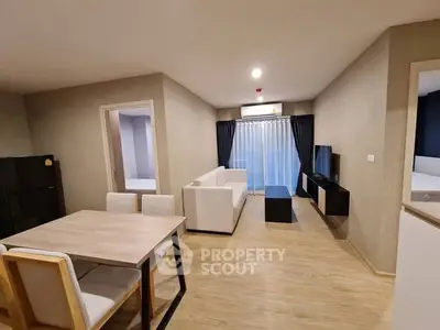 Modern living room with dining area and natural light
