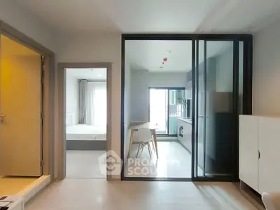 Modern apartment interior with open layout kitchen and bright bedroom view.