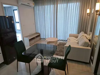 Modern living room with sleek furniture and large windows in a stylish apartment.