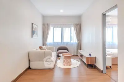 Modern living room with stylish furniture and natural light, featuring a cozy sofa and chic decor.